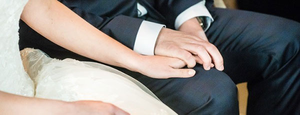 Wedding couple holding hands